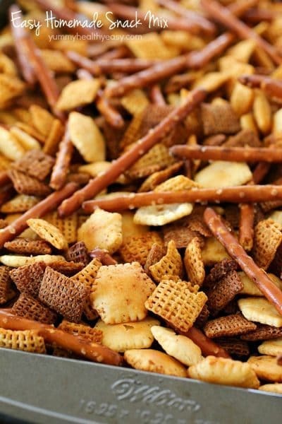 This Homemade Snack Mix Recipe is so easy to make and tastes delicious! Cereal, crackers and pretzels are tossed with a little butter and seasonings, then baked. Perfect to serve at a party or to munch on when you're watching the game. :)