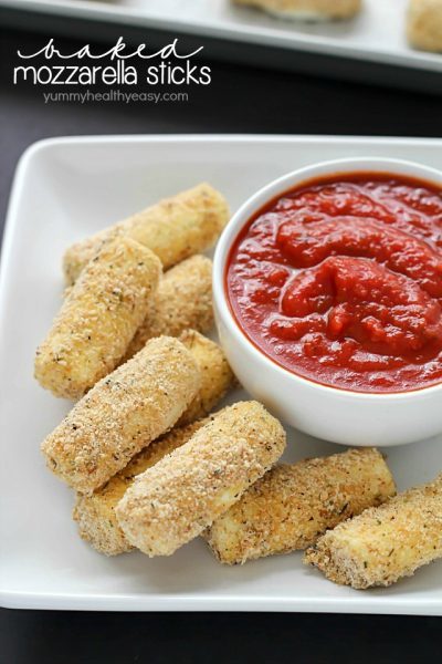 Quick and easy Baked Mozzarella Sticks for the win! A fast crowd-pleasing appetizer of warm and gooey cheese dipped in marinara sauce - yum!