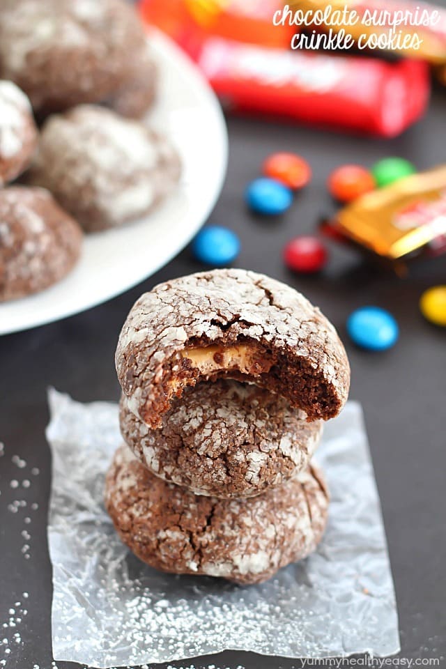 Chocolate Surprise Crinkle Cookies filled with pieces of your favorite candy inside and rolled in powdered sugar - the best way to use up any leftover candy! #cookies #halloween #leftovercandy #dessert #chocolate #surprise via @jennikolaus