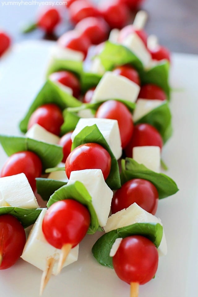 Summer afternoons call for these fun Caprese Skewers! Cherry tomatoes, fresh basil and cubes of mozzarella cheese threaded on skewers and drizzled with an easy balsamic reduction. Delicious!