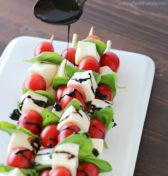 Summer afternoons call for these fun Caprese Skewers! Cherry tomatoes, fresh basil and cubes of mozzarella cheese threaded on skewers and drizzled with an easy balsamic reduction. Delicious!