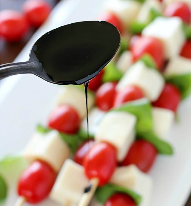 Summer afternoons call for these fun Caprese Skewers! Cherry tomatoes, fresh basil and cubes of mozzarella cheese threaded on skewers and drizzled with an easy balsamic reduction. Delicious!