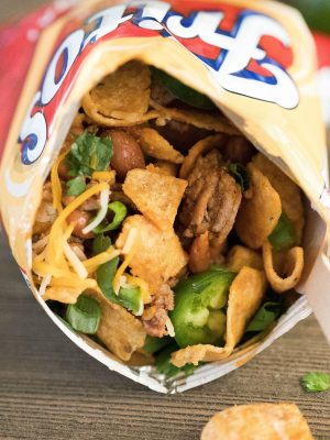 Close up of a Frito snack size bag filled with taco mixture and toppings. Yum!