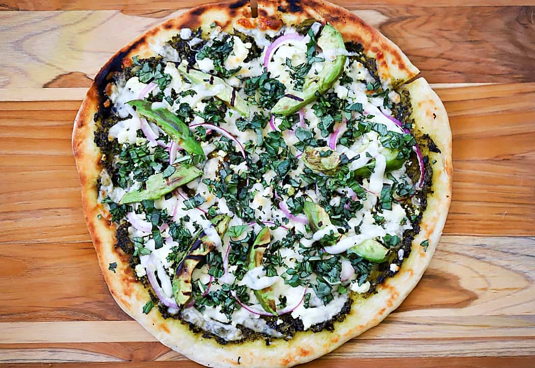 Horizontal overhead view of finished, uncut pizza.