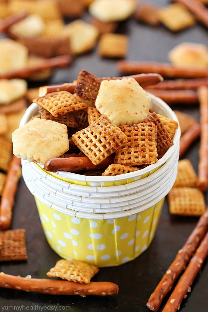 This Homemade Snack Mix Recipe is so easy to make and tastes delicious! Cereal, crackers and pretzels are tossed with a little butter and seasonings, then baked. Perfect to serve at a party or to munch on when you're watching the game. :)