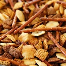 This Homemade Snack Mix Recipe is so easy to make and tastes delicious! Cereal, crackers and pretzels are tossed with a little butter and seasonings, then baked. Perfect to serve at a party or to munch on when you're watching the game. :)