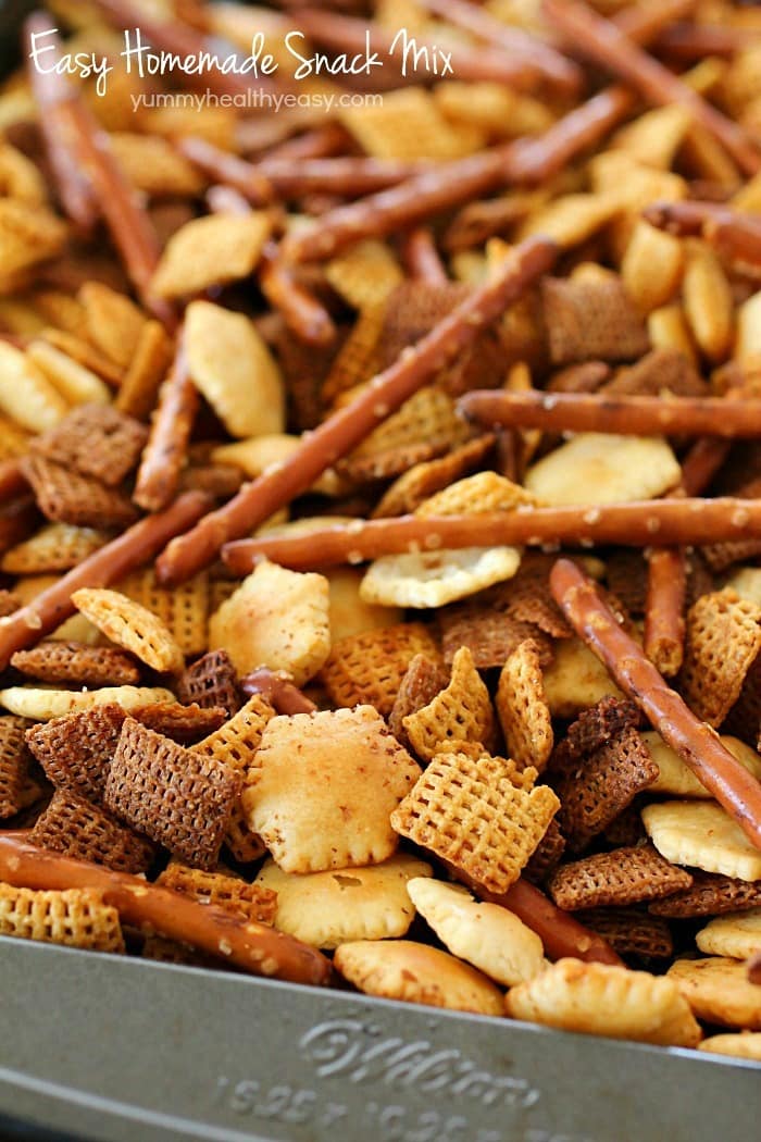 This Homemade Snack Mix Recipe is so easy to make and tastes delicious! Cereal, crackers and pretzels are tossed with a little butter and seasonings, then baked. Perfect to serve at a party or to munch on when you're watching the game. :)
