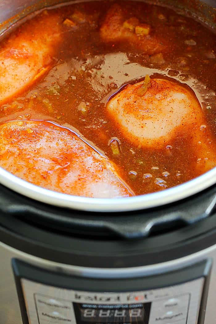 Make dinner EASY with this Instant Pot Salsa Chicken! Just throw a few easy ingredients in the Instant Pot and the result is perfectly tender chicken you can put in taco shells, on salads or just devour all by itself!