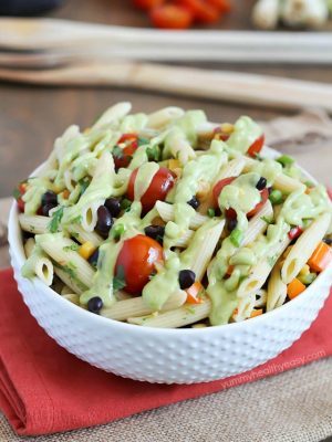 A simply delicious side dish, Mexican Pasta Salad - with black beans, corn, bell pepper, cilantro, tomatoes, and an avocado dressing.