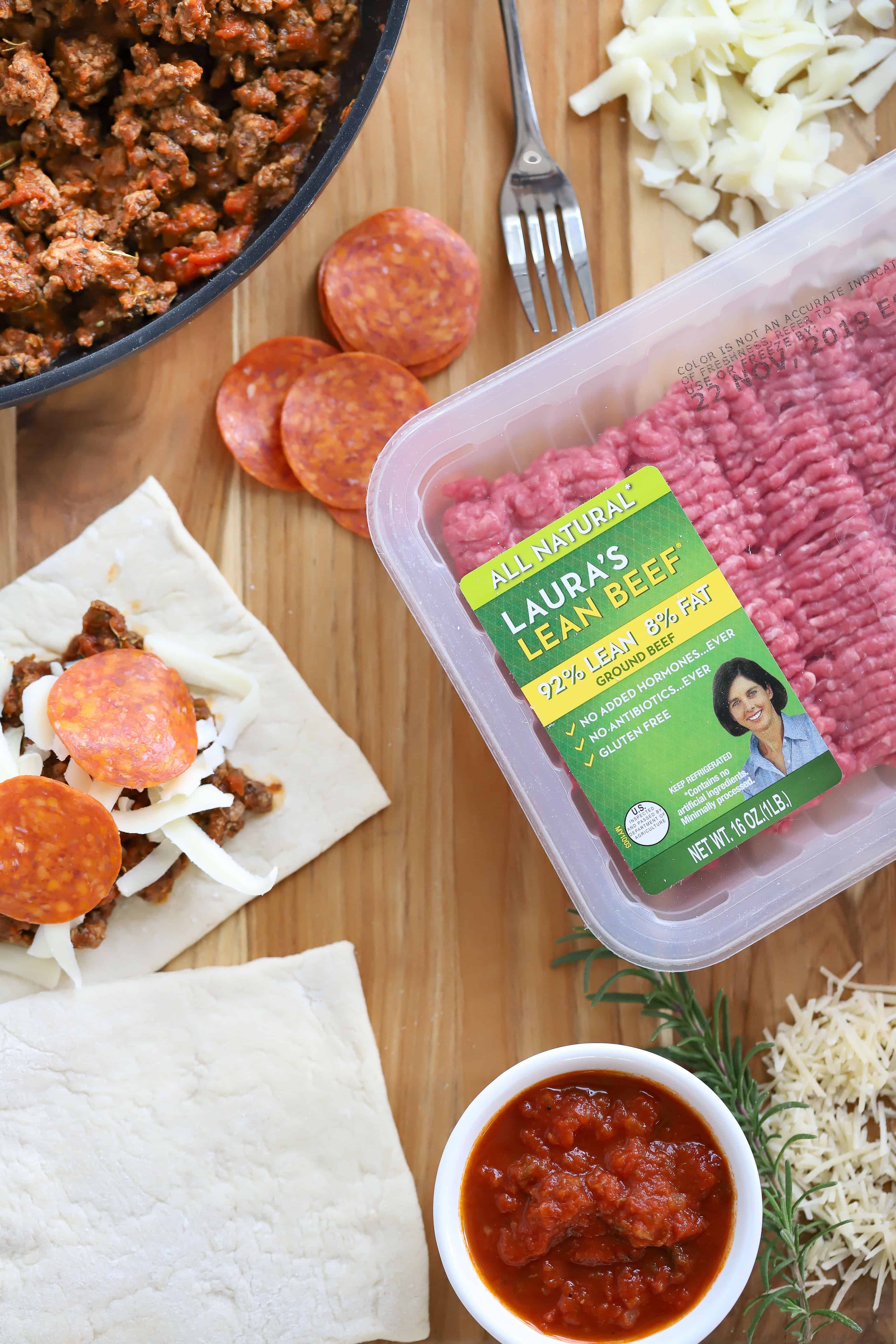 Overhead shot of Laura's Ground Beef, pizza dough, pizza sauce, cheese and ground beef mixture. #ad