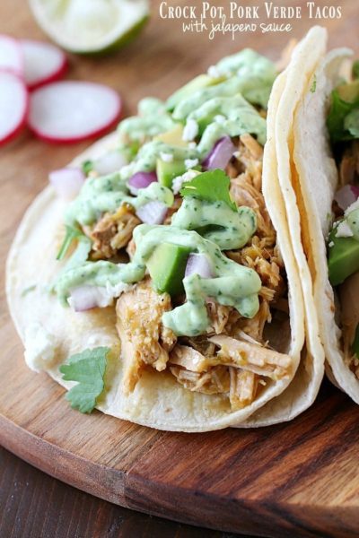 Pork Verde Tacos cooked in the crock pot and served with a drizzle of amazing jalapeño sauce. You will love the flavor in these pork tacos and love how easy they are to make! AD