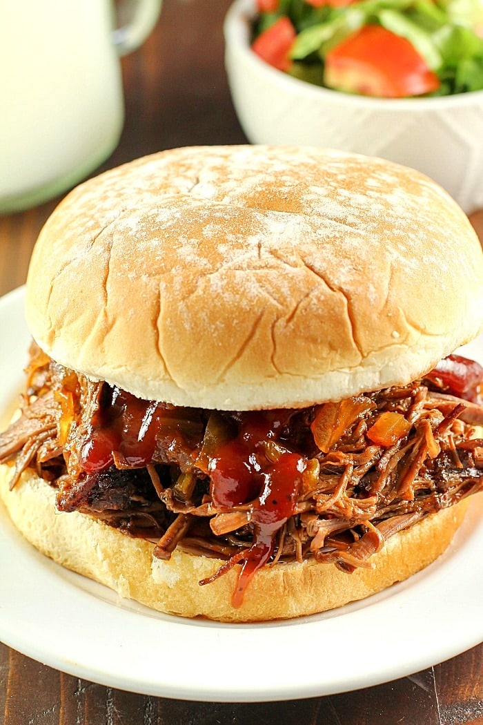 Slow Cooker Shredded Beef Sandwiches are one of my family's favorite make-ahead dinners! Cooked right in the crock pot with an easy & flavorful sauce, makes this beef roast tender and perfect for filling sandwiches/buns! Great to serve for dinner or for a party!