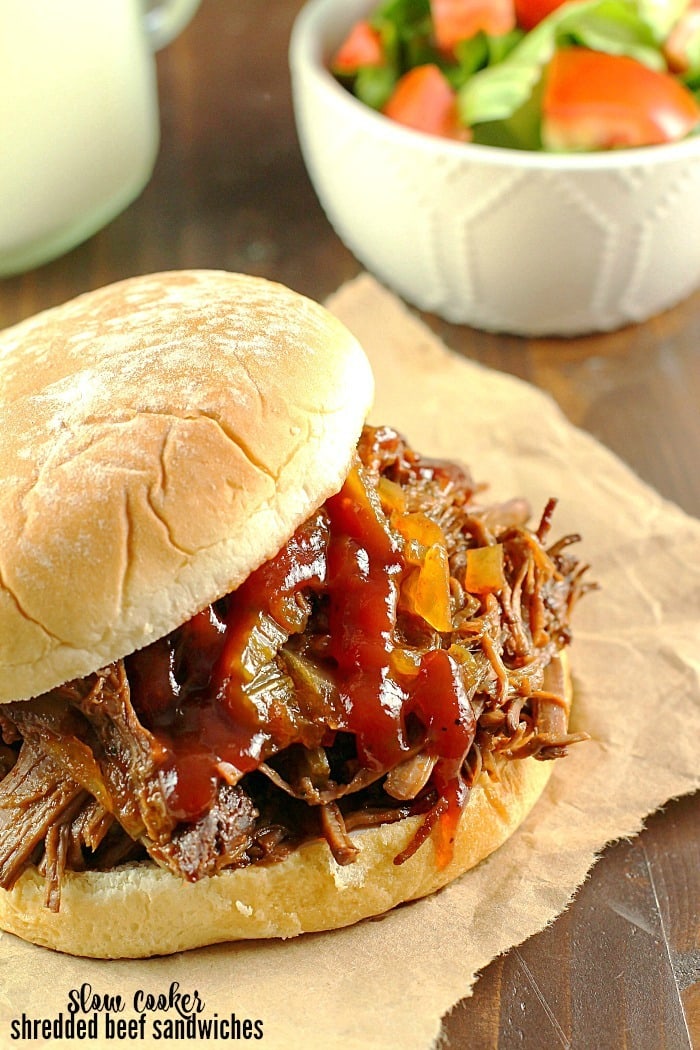 Slow Cooker Shredded Beef Sandwiches are one of my family's favorite make-ahead dinners! Cooked right in the crock pot with an easy & flavorful sauce, makes this beef roast tender and perfect for filling sandwiches/buns! Great to serve for dinner or for a party!