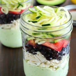 Avocado dressing (southwest style!) is nestled on the bottom of this delicious mason jar salad with zucchini noodles on the top and chicken, veggies and black beans tucked in the middle. A delicious and healthy low-carb, low-sugar lunch prepared ahead of time and eaten on-the-go! Plus a HUGE Blendtec Giveaway you won't want to miss!!