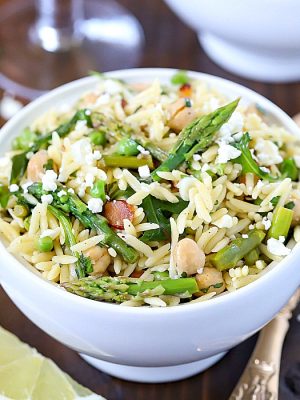 Beautiful Spring Orzo Salad filled with orzo, asparagus, toasted almonds, arugula, feta cheese and peas with a vinaigrette.