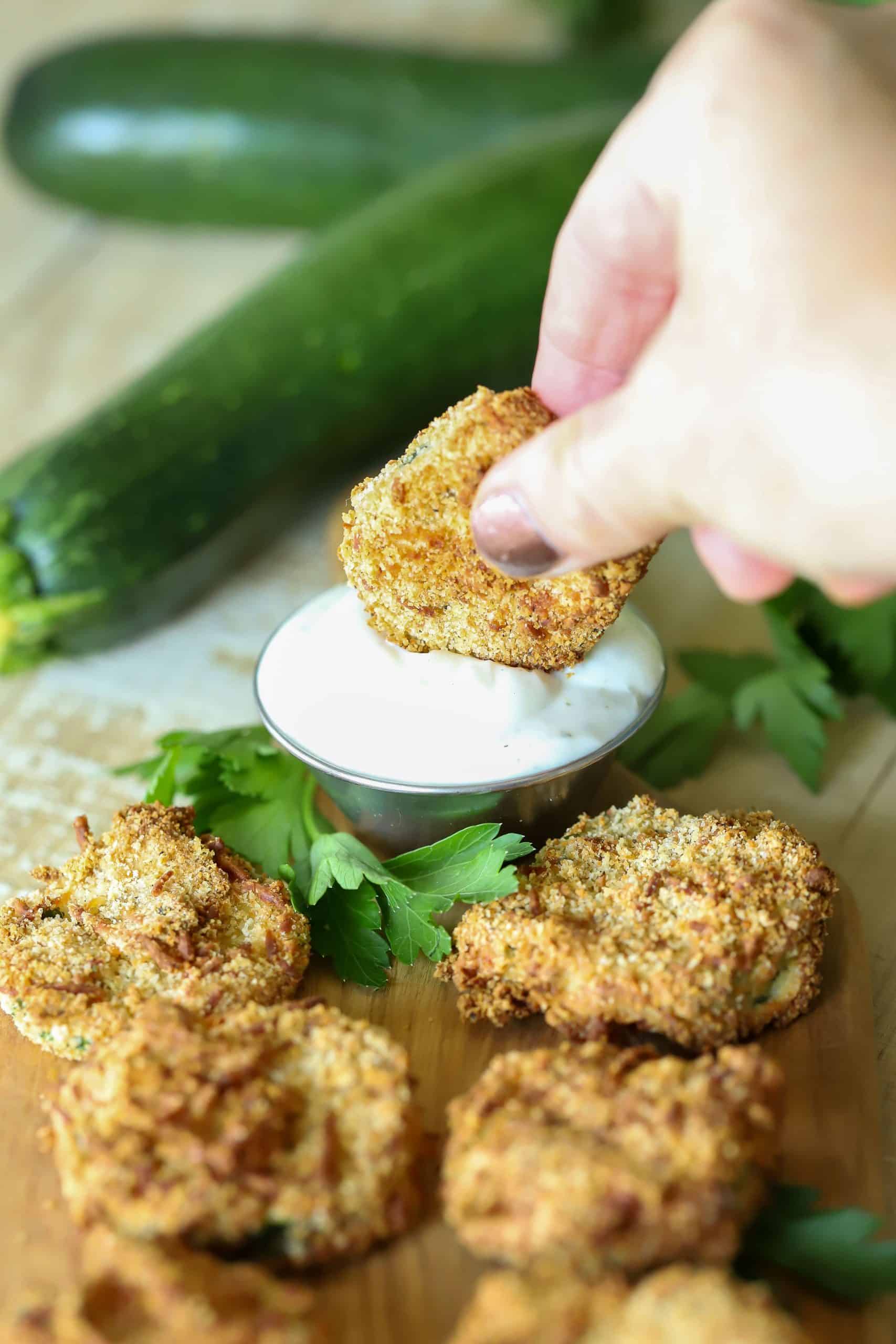 Easy Air Fryer Zucchini Chips are the perfect snack or side dish. Serve with a healthy Greek yogurt and ranch dipping sauce, and you won't stop snacking on them! #airfryer #appetizer #snack #zucchini #healthyrecipe #healthy via @jennikolaus